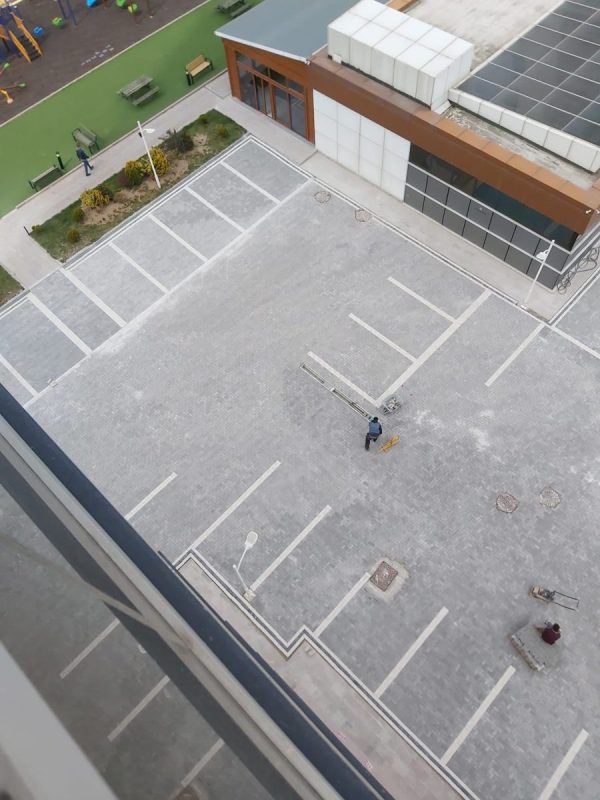 Kuşbakışı parke taşı ile döşenmiş otopark ve park çizgileri